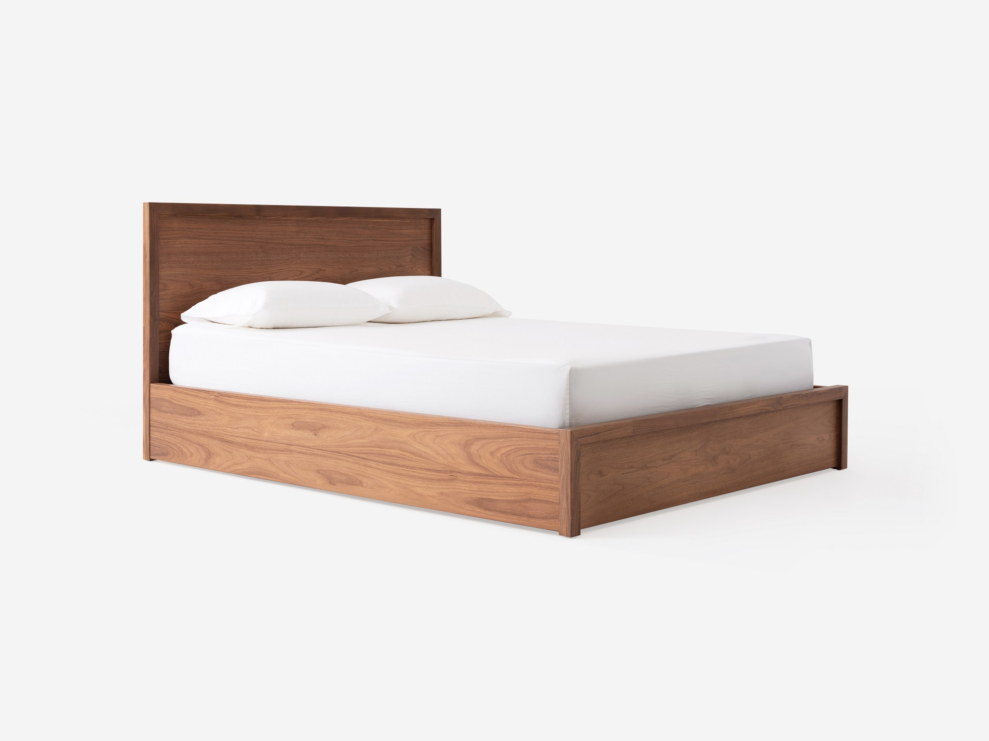 Angled view of our walnut Marcel panel bed